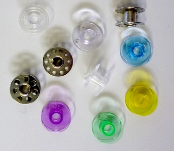 Bobbins for sewing machines